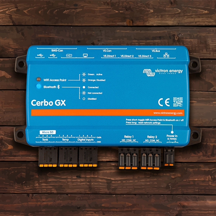 Victron Energy Cerbo GX networking hub on a wood background.
